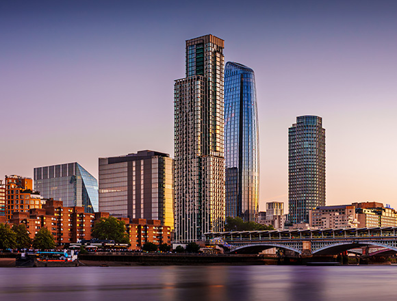city skyline with modern skyscrapers at sunset featuring vibrant reflections on the water showcasing architectural beauty near the river 15 stunning buildings 15 urban landscape 15 city view